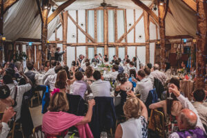 Celebrations during wedding speeches at South Farm wedding venue in Royston